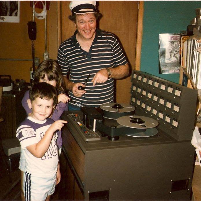 Wes as a small boy with his sister and father at a reel-to-reel tape machine